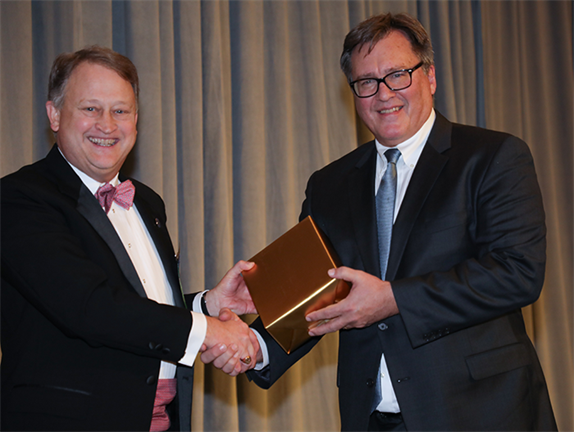 President Benjamin D. Leigh presents the Roger D. Groot Pro Bono Publico Award to Scott C. Oostdyk